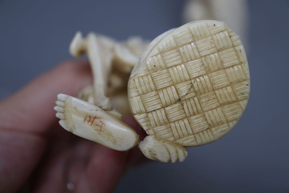 A Japanese ivory okimono of an elder and a dragon, and a marine ivory carving of Daikoku, tallest 25cm